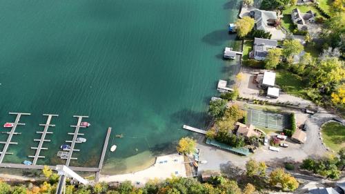 an aerial view of a house on the shore of a lake at Canandaigua Lake Retreat with view and private beach access, foliage, hike, and Ski in Canandaigua