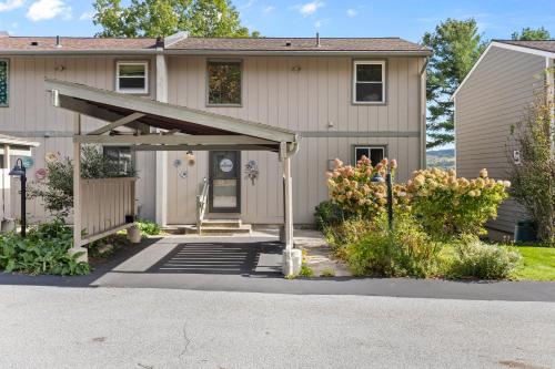 a house with an awning in front of it at Canandaigua Lake Retreat with view and private beach access, foliage, hike, and Ski in Canandaigua
