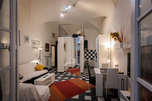 a living room with a couch and a table at Nik rooms in Genoa