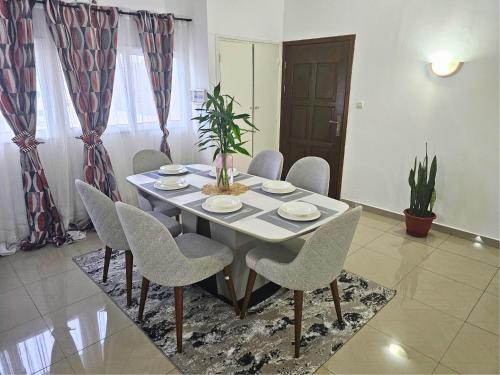 a dining room with a table and chairs at MP's Residence 202 in Pointe-Noire