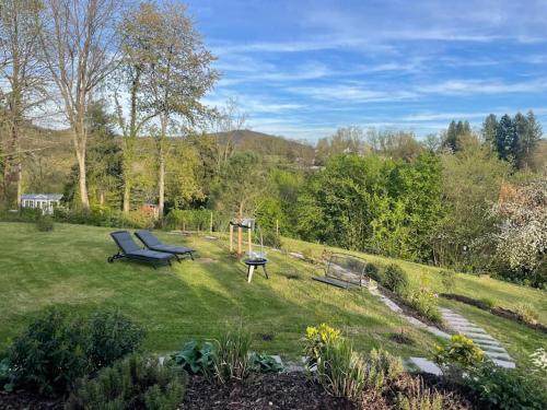a garden with a bench in the grass at Haus Sonnenhang in Hauenstein
