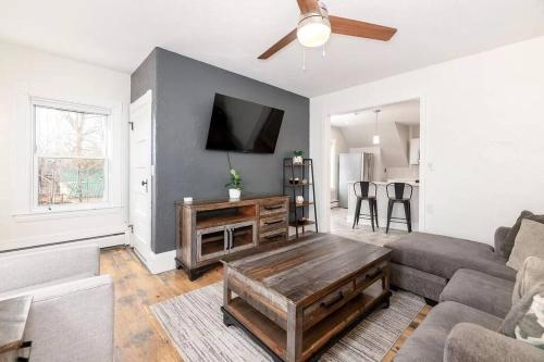 a living room with a couch and a table at 2-Unit House, big Lake Winnisquam views - Sleeps 13 in Tilton