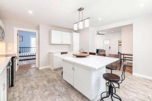 a kitchen with white cabinets and a white counter top at 2-Unit House, big Lake Winnisquam views - Sleeps 13 in Tilton