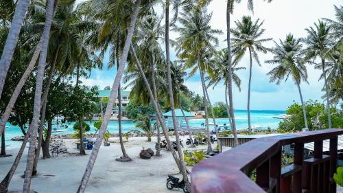 a view of a beach with palm trees and the ocean at Silver Oasis Maldives in Huraa