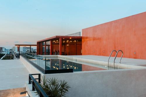 a swimming pool on the roof of a building at Everglades Suites in Cancún