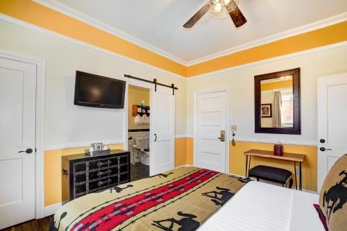 a bedroom with a bed and a tv on the wall at Hotel St. Michael, BW Premier Collection in Prescott