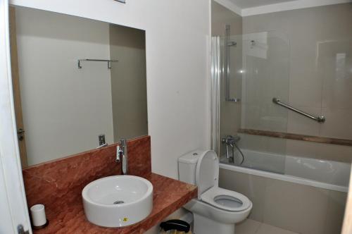 a bathroom with a toilet and a sink and a shower at Beach Villa Pantheon in Pomos