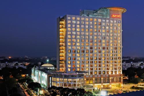a large building with a sign on top of it at Bengaluru Marriott Hotel Whitefield in Bengaluru