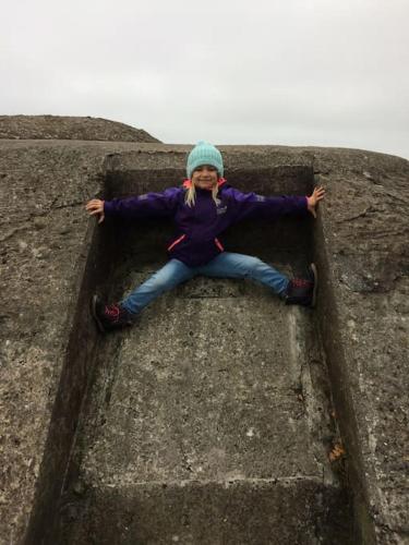 a young girl sitting on top of a wall at Enjoy nature in silence in Ljungen