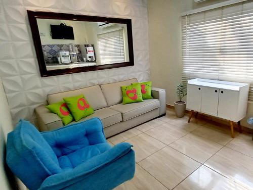 a living room with a couch and a chair at Flat Duplex - Flat & Residence Premium in Campo Grande