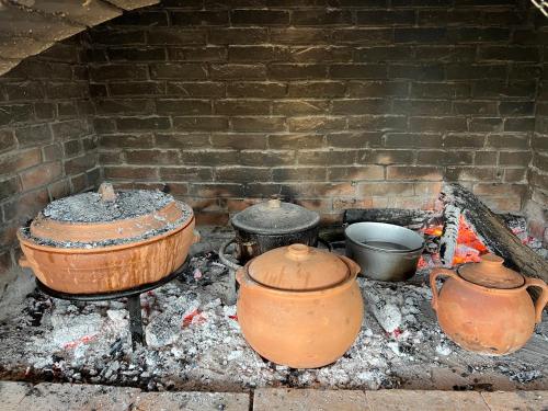 a group of pots and pans on a brick oven at Eko farma Kladovo in Kladovo