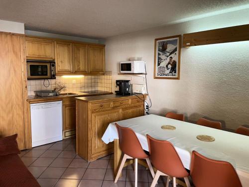 Il dispose d'une cuisine avec une table et des chaises. dans l'établissement Résidence Les Jardins Alpins - Jardins Alpins B03 MAE-5231, à Saint-Gervais-les-Bains