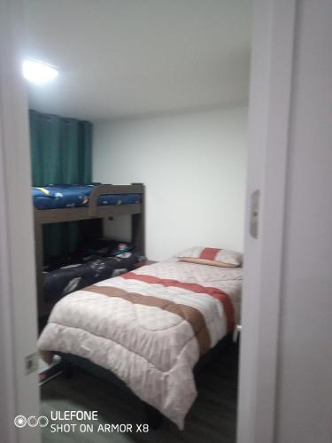 a small bedroom with a bed in a room at DeptoIquique in Iquique