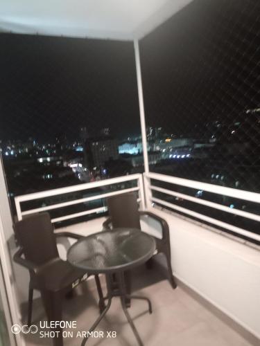 two chairs and a table on a balcony with a view at DeptoIquique in Iquique