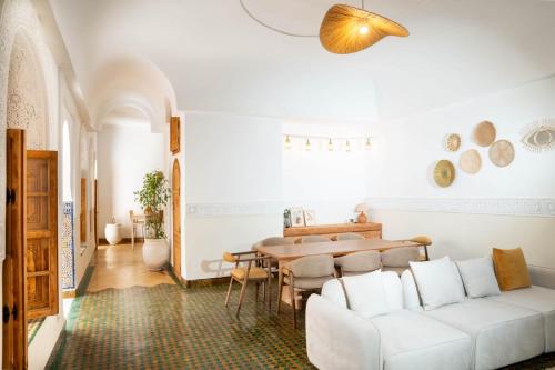 a living room with a white couch and a table at Riad Tamazigh in Marrakech