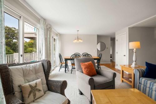 a living room with a couch and chairs and a table at Water Views Walk to Beach Dogs Welcome in Brewster