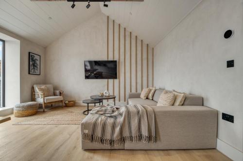 a living room with a couch and a table at Panoramic Sea View Apartment in The Mumbles
