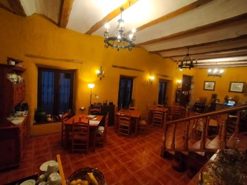 a dining room with tables and chairs and a chandelier at Casa Rural Garrido in Ademuz