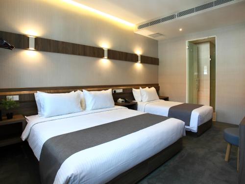 Ένα ή περισσότερα κρεβάτια σε δωμάτιο στο Arcadia Hotel