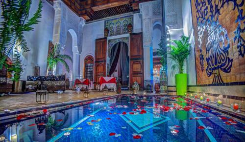 a large swimming pool in a large room at Riad Almaz in Fez