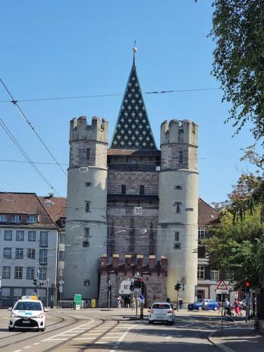 a building with two towers with cars in front of it at New tiny studio 2 near Uni & Hospital in Basel