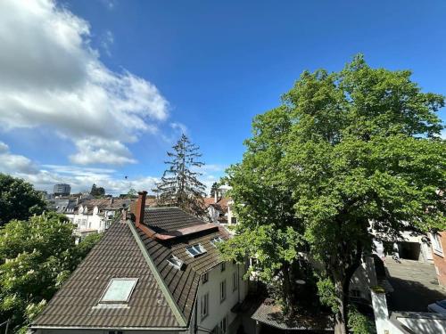 a view of a city with buildings and a tree at New tiny studio 2 near Uni & Hospital in Basel