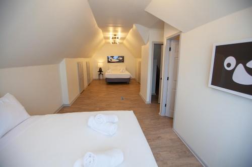a bedroom with a white bed with towels on it at Onyx Hotels in Austin