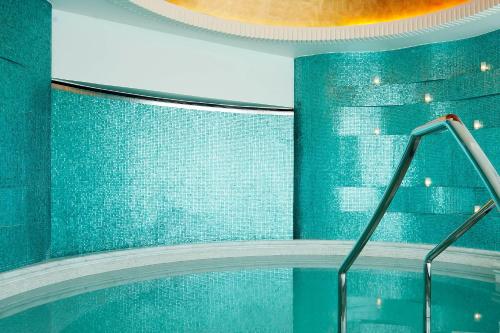 a bathroom with a blue wall and a tub at The St. Regis Abu Dhabi in Abu Dhabi