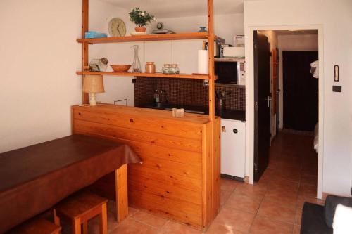 - une cuisine avec un meuble en bois dans une pièce dans l'établissement Résidence L'oustal - Grand studio 4 personnes MAE-0121, aux Orres