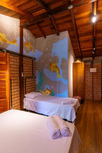 a bedroom with two beds and a mural of fishes at Casa do Lago em Alter do Chão in Alter do Chao