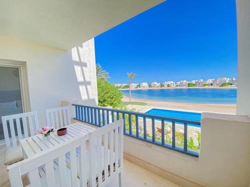 a balcony with a view of the beach and water at Nayah Stays, Joubal Lagoons flowery apartment in Hurghada