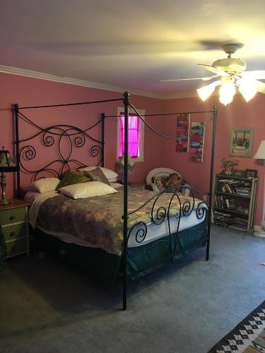 a bedroom with a large bed with a metal frame at Elaine's Hollywood Bed & Breakfast in Los Angeles