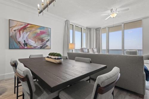 a dining room with a wooden table and chairs at Perdido Dunes Tower 6E condo in Orange Beach