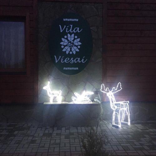 a sign that says virza versani with deer and lights at Vila Viesai in Trakai