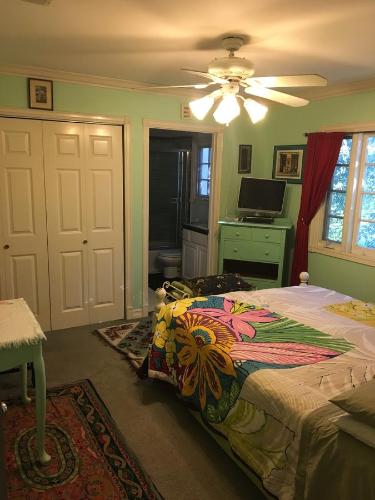a bedroom with a bed and a ceiling fan at Elaine's Hollywood Bed & Breakfast in Los Angeles
