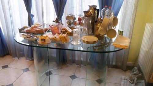 a glass table with food on top of it at Villa Fiorita in Monfalcone
