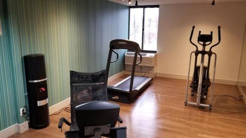 a room with a gym with a treadmill and a window at Holiday Inn Express Rochester-Greece in Greece