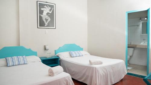 Una cama o camas en una habitación de Hotel Petenchel