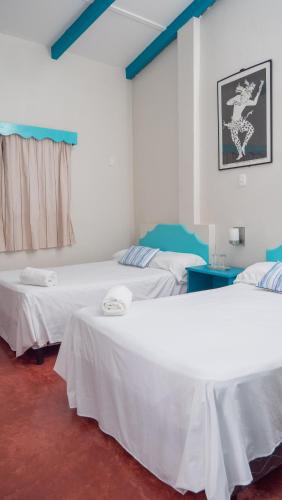 Una cama o camas en una habitación de Hotel Petenchel