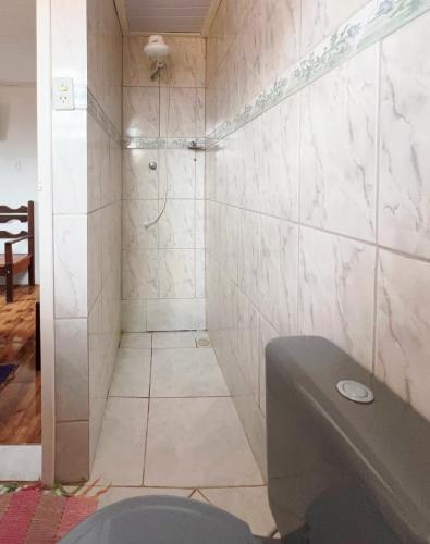a bathroom with a shower and a sink at Suítes Cantinho Gostoso in Lavras Novas