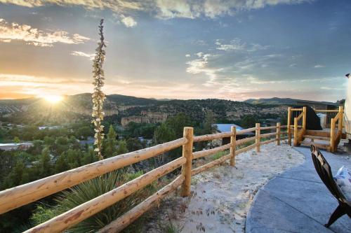 a view of the sunset from a wooden fence at Yurt Overlook #6 with AC and Private Bath 2 Kings in Orderville