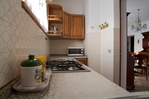 a kitchen with a stove and a counter top at B&B Colli's Dolomites in Belluno