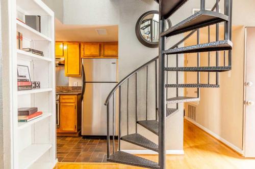 a spiral staircase in a kitchen with a refrigerator at Onyx Hotels in Austin