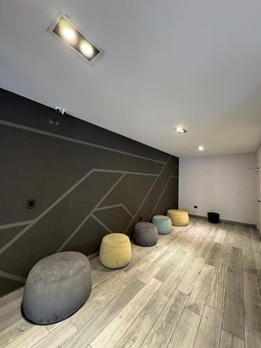 three stools in a room with a wall at APART Caballito II in Buenos Aires