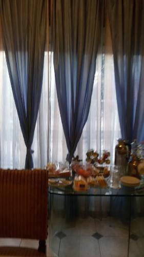 a table with blue drapes and food on it at Villa Fiorita in Monfalcone