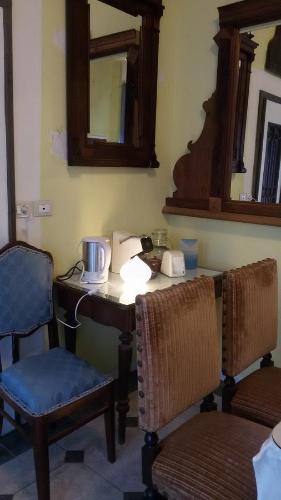 a room with a table and two chairs and a mirror at Villa Fiorita in Monfalcone