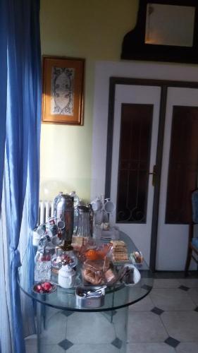a glass table with food on top of it at Villa Fiorita in Monfalcone