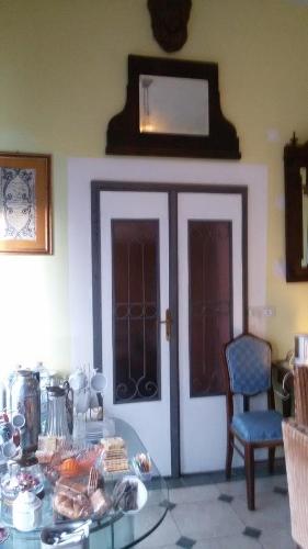 a room with a glass table with food on it at Villa Fiorita in Monfalcone