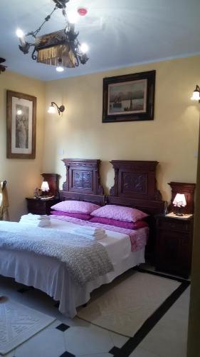 a bedroom with a large bed with purple pillows at Villa Fiorita in Monfalcone