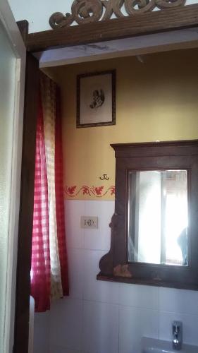 a bathroom with a sink and a mirror and a window at Villa Fiorita in Monfalcone